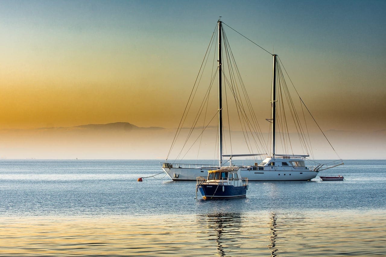 Traditional wooden ketch under sail in Turkish waters showing the two-mast rig — mainmast forward, shorter mizzen stepped ahead of the rudder post — distinguishing it from a yawl where the mizzen is aft of the rudder